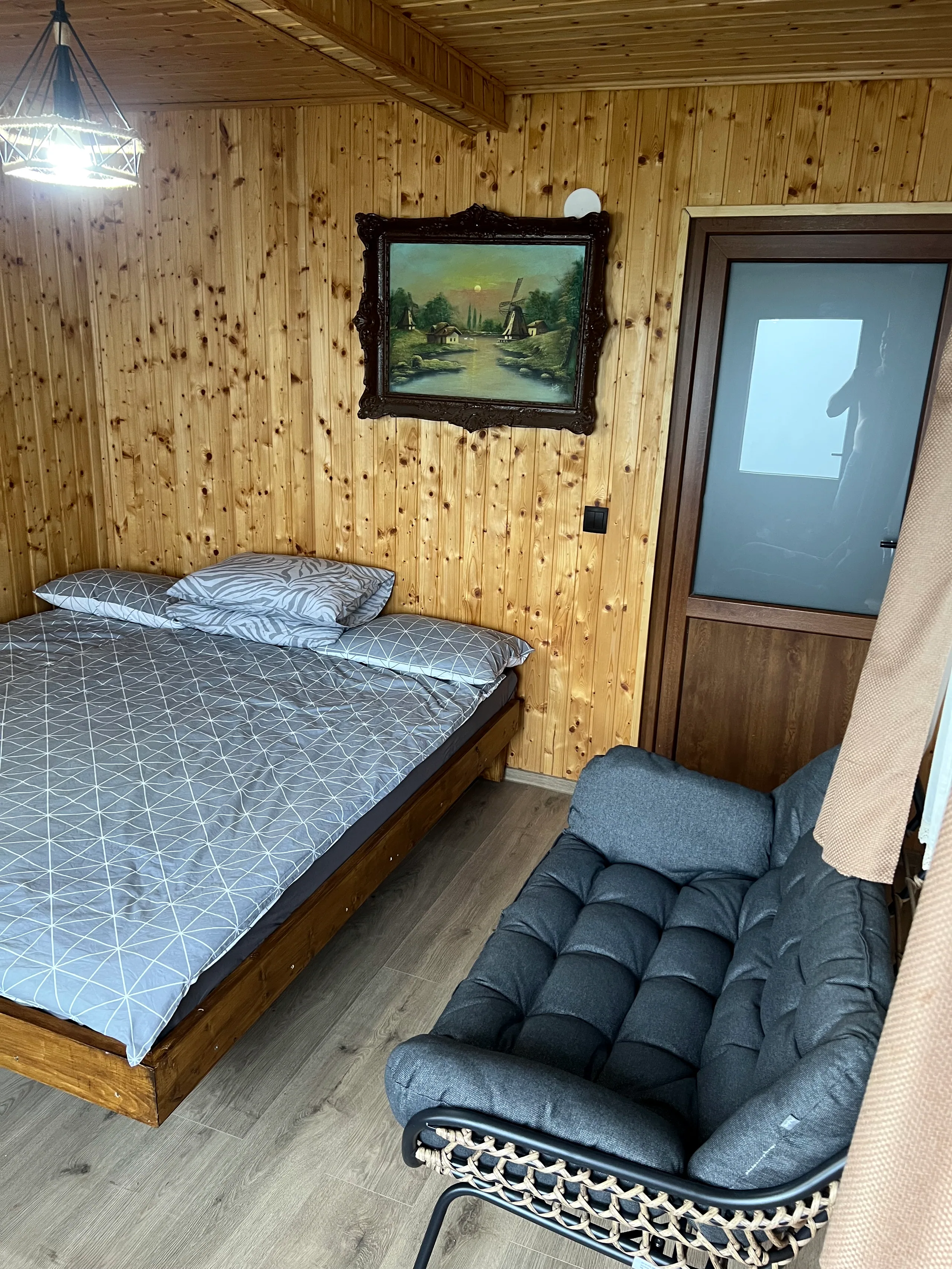 Bedroom detail with a vintage painting above the bed